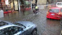 A cyclist pushes through floodwaters in Brunswick